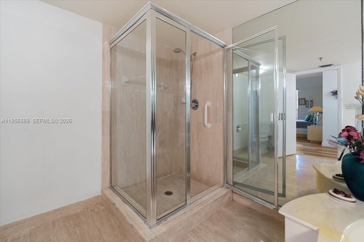 7201 Promenade Drive, Unit 101 Boca Raton, FL 33433 - Photo 32 of 54 a bathroom with a shower and a mirror