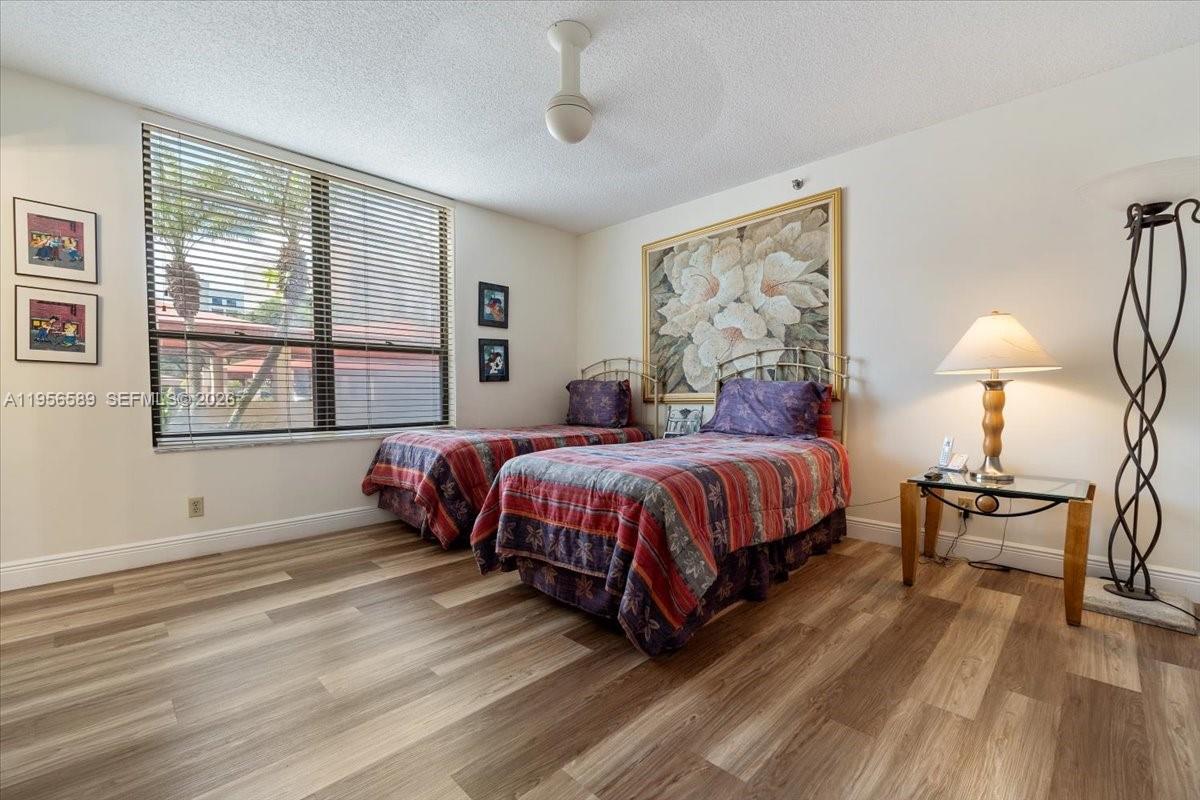 7201 Promenade Drive, Unit 101 Boca Raton, FL 33433 - Photo 35 of 54 a spacious bedroom with a large bed and a window