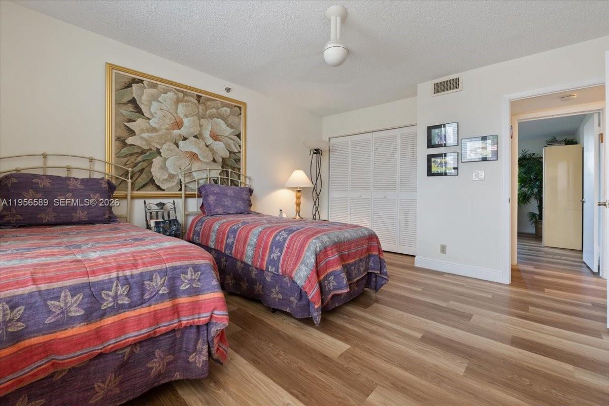 7201 Promenade Drive, Unit 101 Boca Raton, FL 33433 - Photo 36 of 54 a bedroom with two beds and painting on the wall