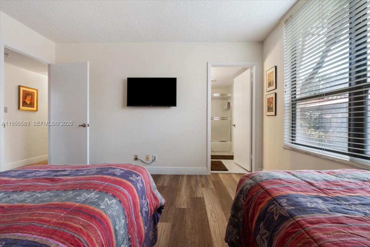 7201 Promenade Drive, Unit 101 Boca Raton, FL 33433 - Photo 37 of 54 a bedroom with a bed and a flat screen tv