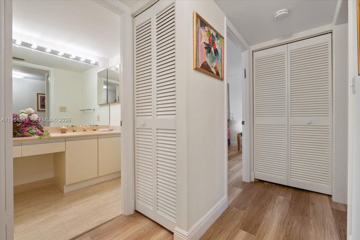 7201 Promenade Drive, Unit 101 Boca Raton, FL 33433 - Photo 38 of 54 a bathroom with a sink cabinets and a mirror