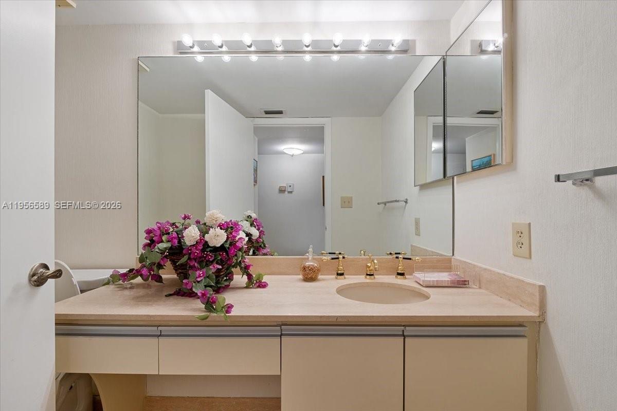 7201 Promenade Drive, Unit 101 Boca Raton, FL 33433 - Photo 39 of 54 a bathroom with a sink and a mirror