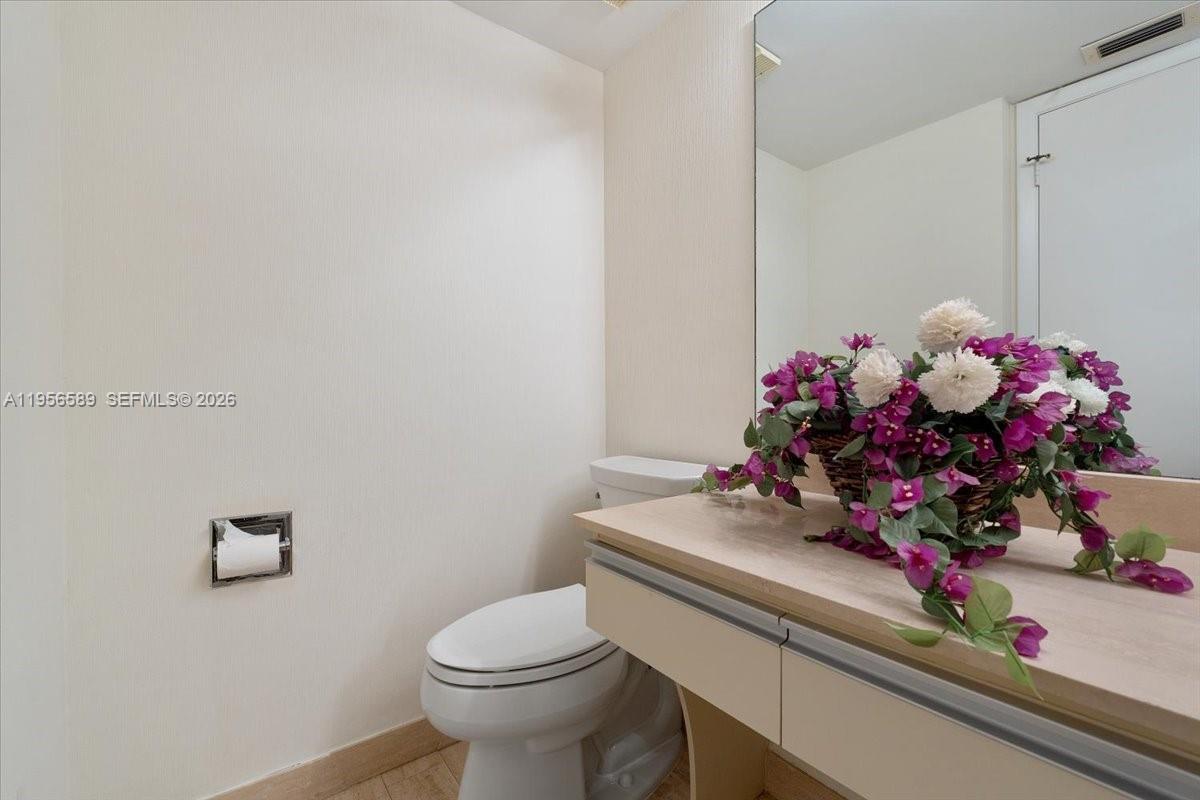 7201 Promenade Drive, Unit 101 Boca Raton, FL 33433 - Photo 40 of 54 a bathroom with a sink mirror and toilet