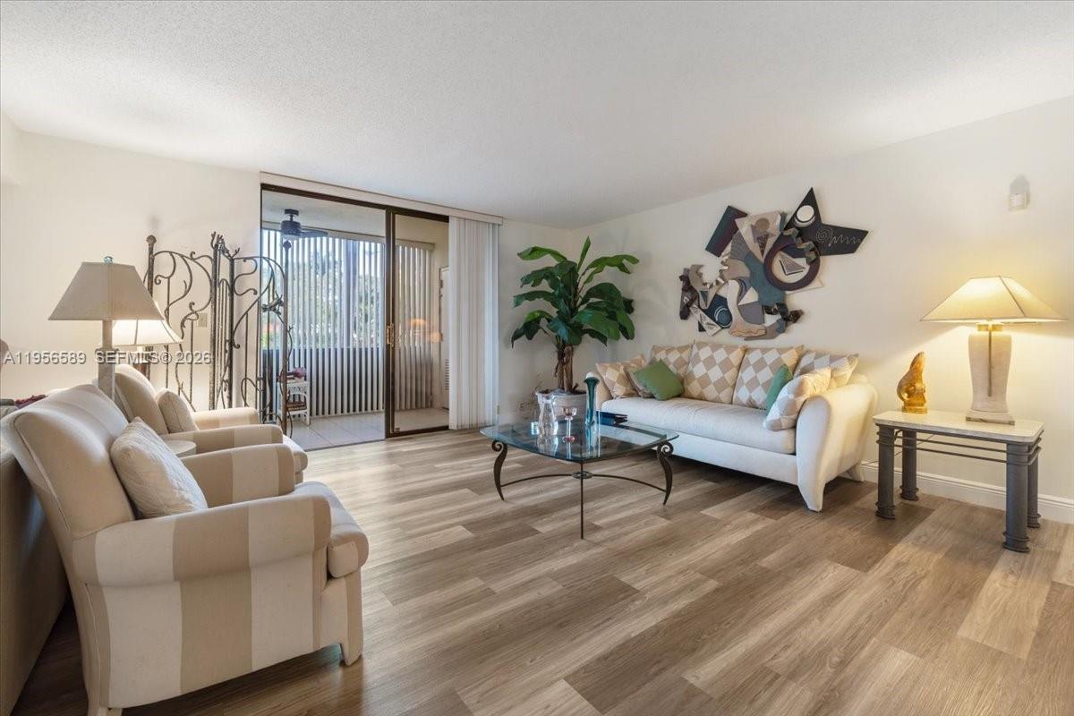 7201 Promenade Drive, Unit 101 Boca Raton, FL 33433 - Photo 4 of 54 a living room with furniture and a potted plant