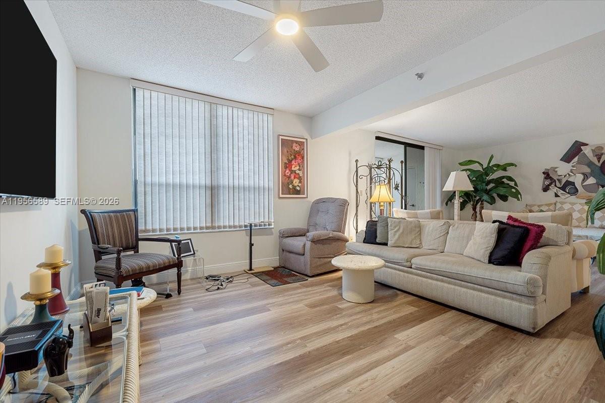 7201 Promenade Drive, Unit 101 Boca Raton, FL 33433 - Photo 6 of 54 a living room with furniture or couch and a wooden floor