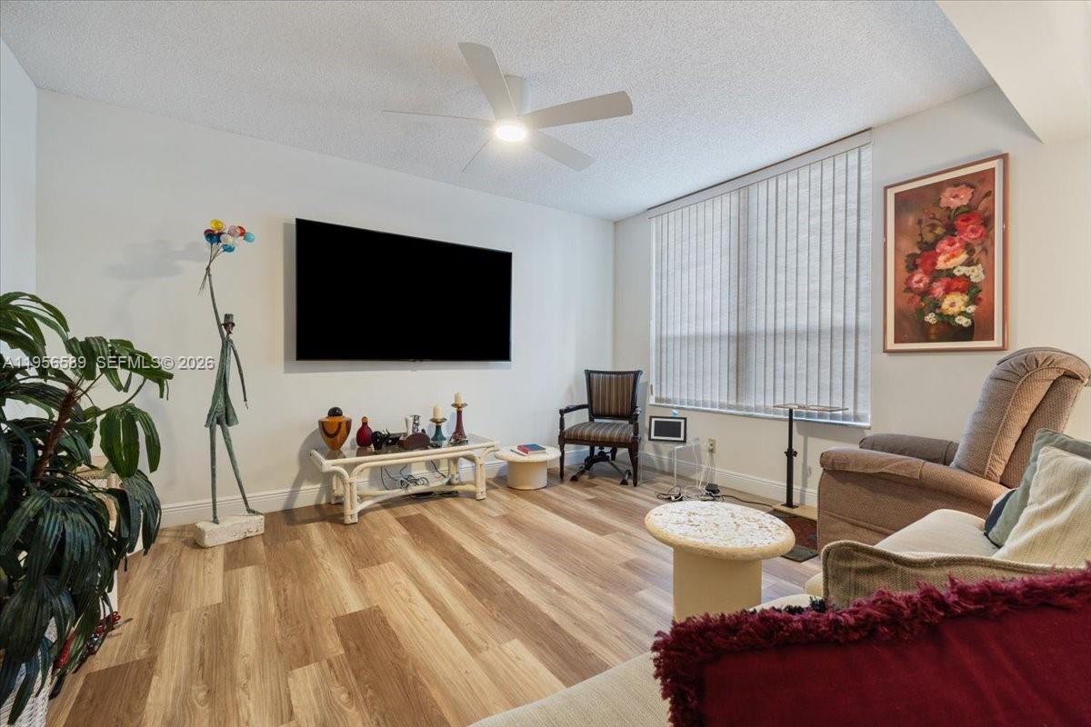 7201 Promenade Drive, Unit 101 Boca Raton, FL 33433 - Photo 7 of 54 a living room with furniture and a flat screen tv