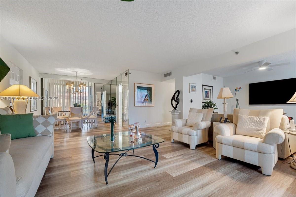 7201 Promenade Drive, Unit 101 Boca Raton, FL 33433 - Photo 10 of 54 a living room with furniture and a flat screen tv