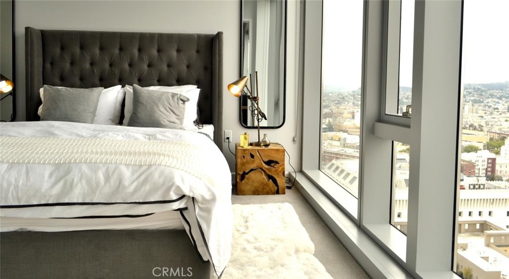 100 Van Ness Avenue, Unit 2315 San Francisco, CA 94102 - Photo 5 of 75 a bedroom with a bed and a large window