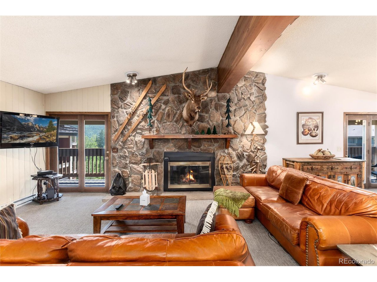 490 Kings Crossing Road, Unit 631 Winter Park, CO 80482 - Photo 4 of 43 a living room with furniture and a fireplace