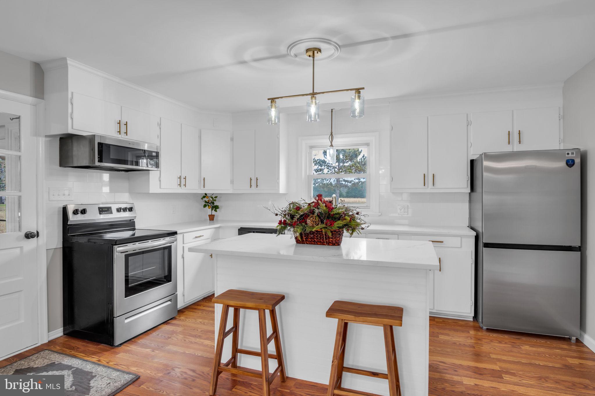 2029 Stoverstown Road Spring Grove, PA 17362 - Photo 13 of 77 a kitchen with stainless steel appliances a stove a sink refrigerator and microwave