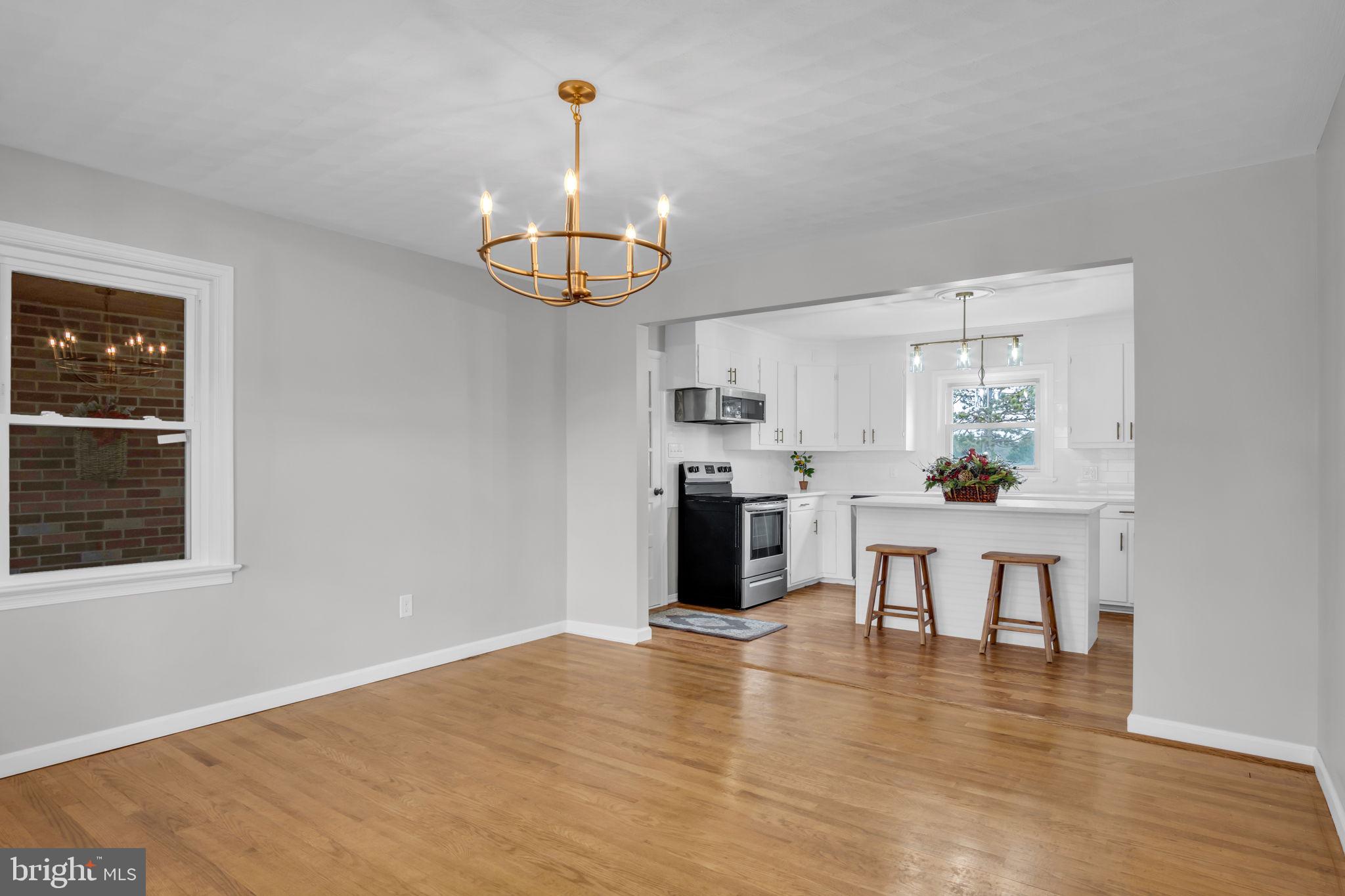 2029 Stoverstown Road Spring Grove, PA 17362 - Photo 18 of 77 a view of a kitchen with stainless steel appliances wooden floor dining table and chairs