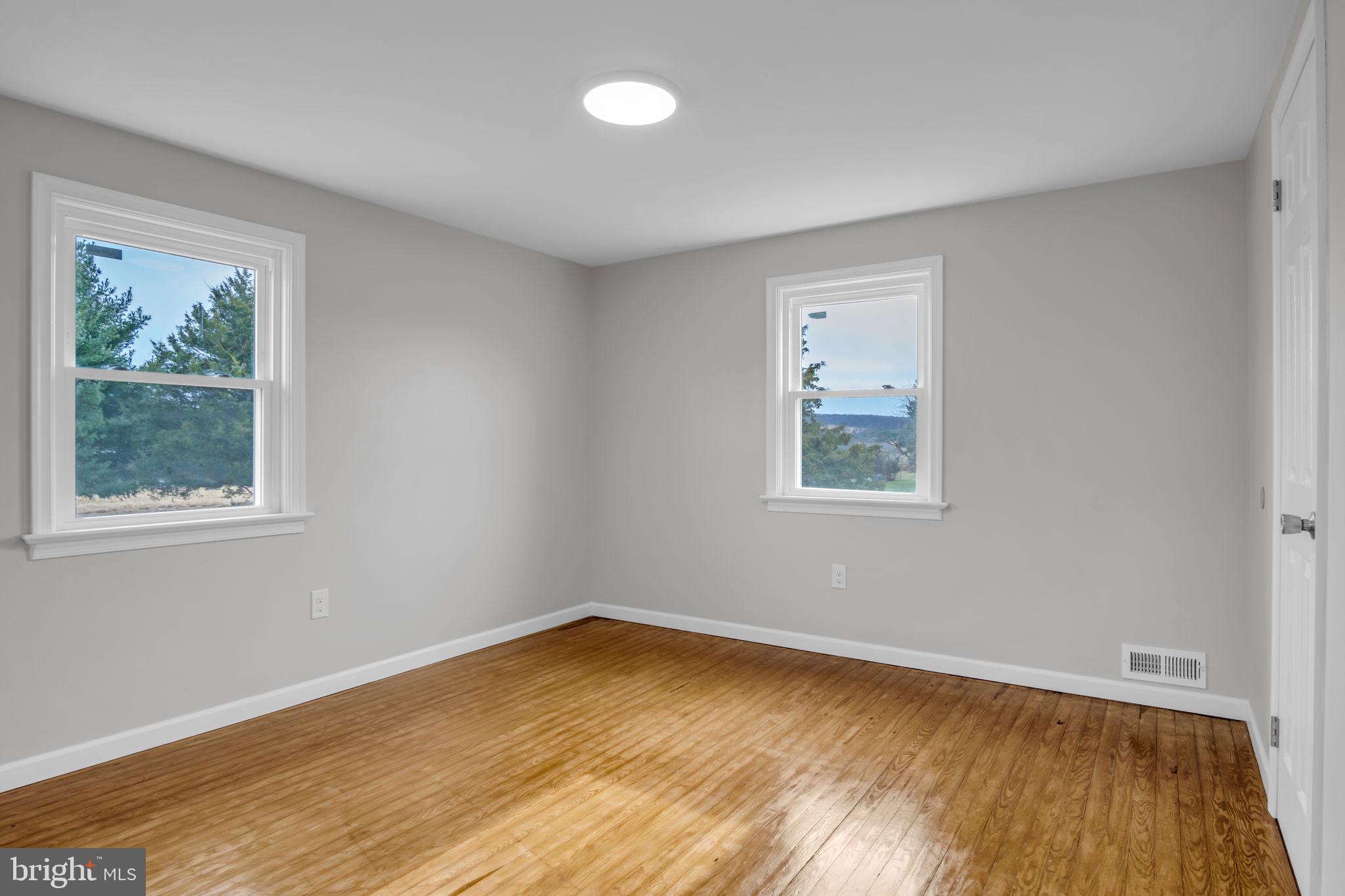 2029 Stoverstown Road Spring Grove, PA 17362 - Photo 35 of 77 a view of an empty room with wooden floor and a window