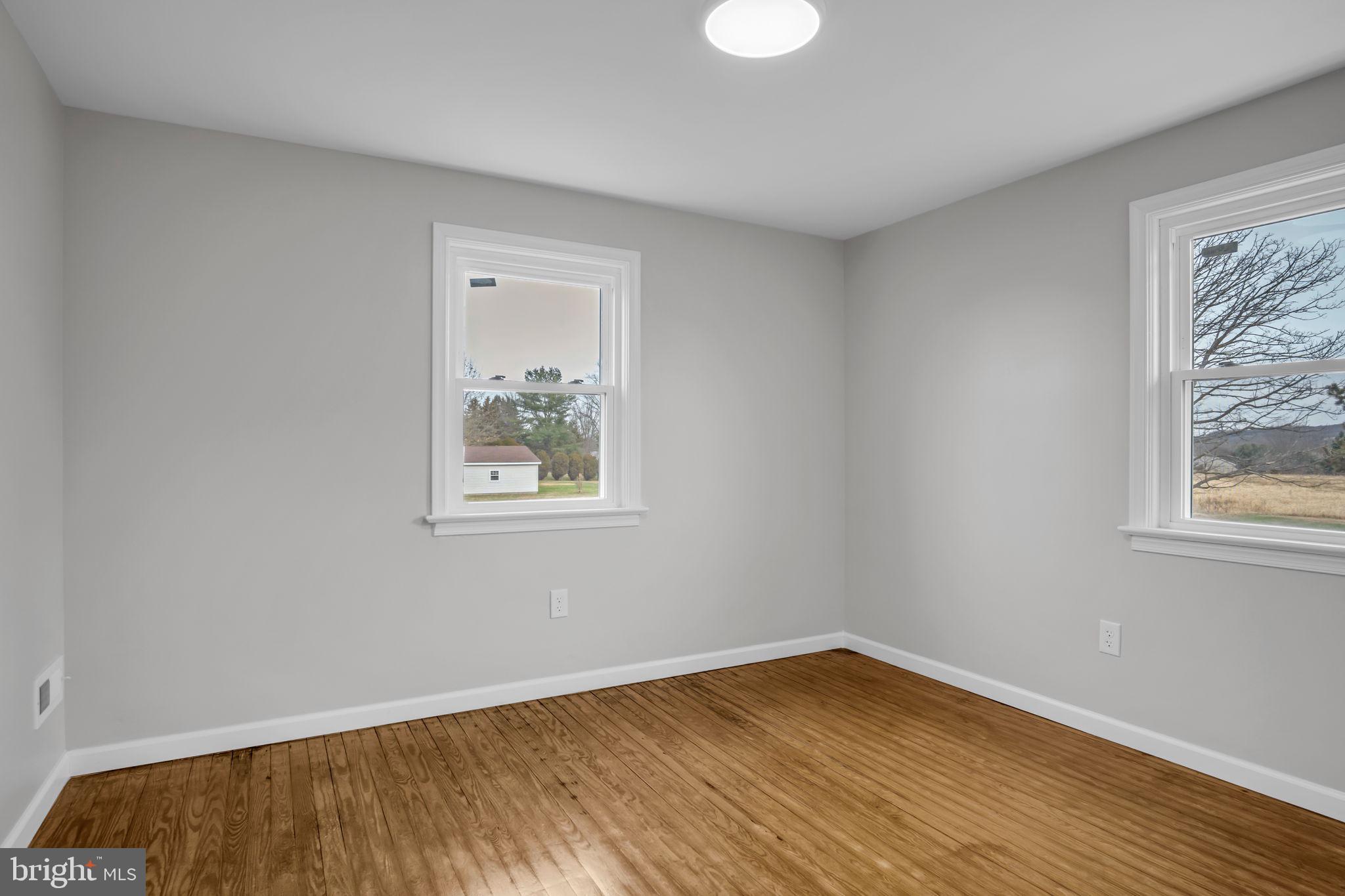 2029 Stoverstown Road Spring Grove, PA 17362 - Photo 39 of 77 a view of an empty room with wooden floor and a window