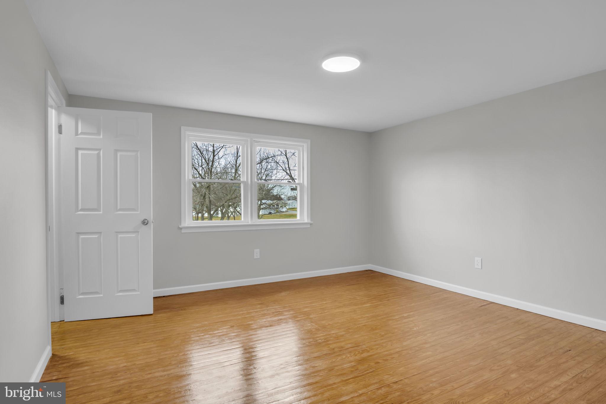 2029 Stoverstown Road Spring Grove, PA 17362 - Photo 42 of 77 a view of an empty room with wooden floor and a window