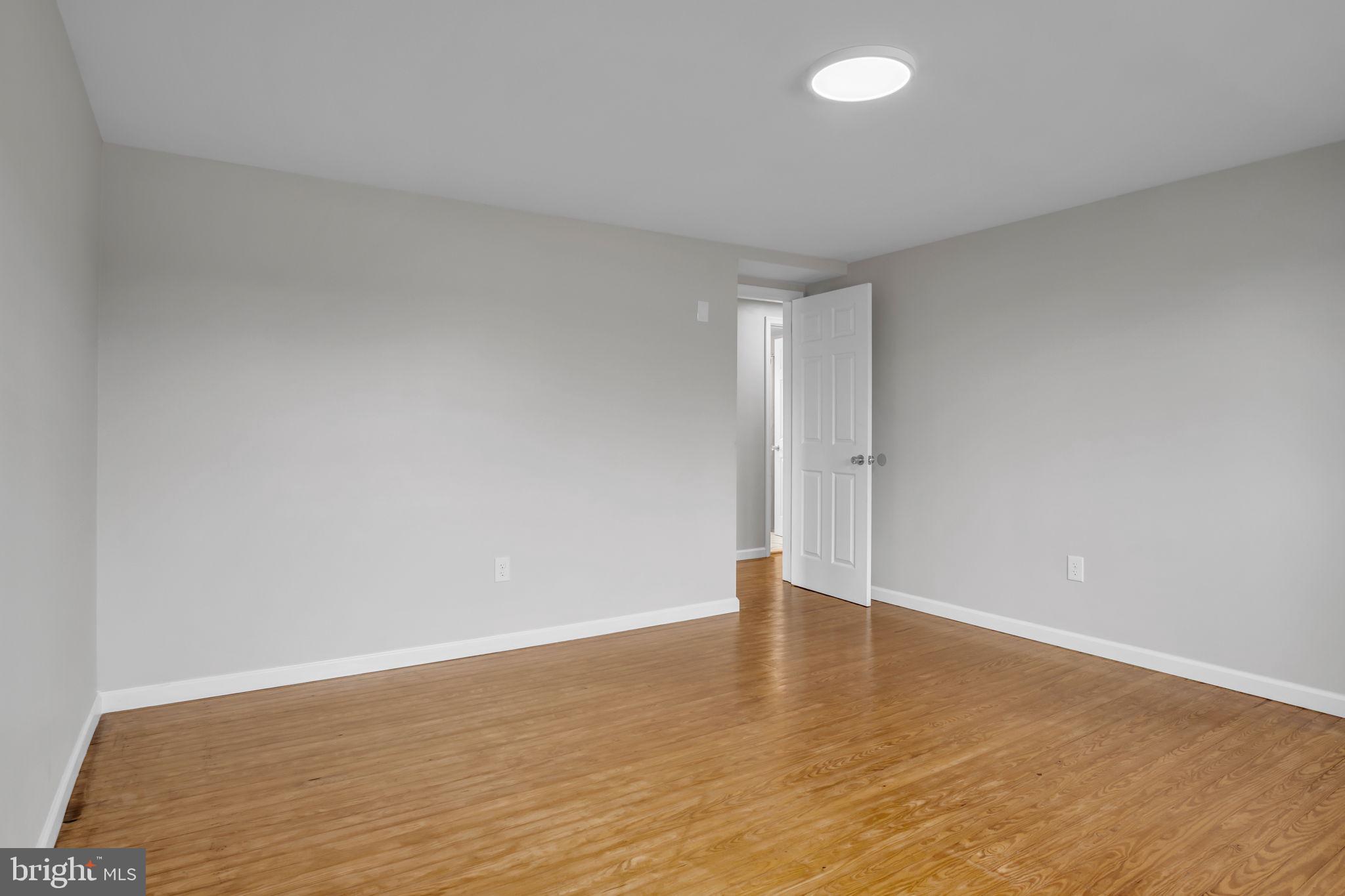 2029 Stoverstown Road Spring Grove, PA 17362 - Photo 44 of 77 a view of an empty room with wooden floor and a window