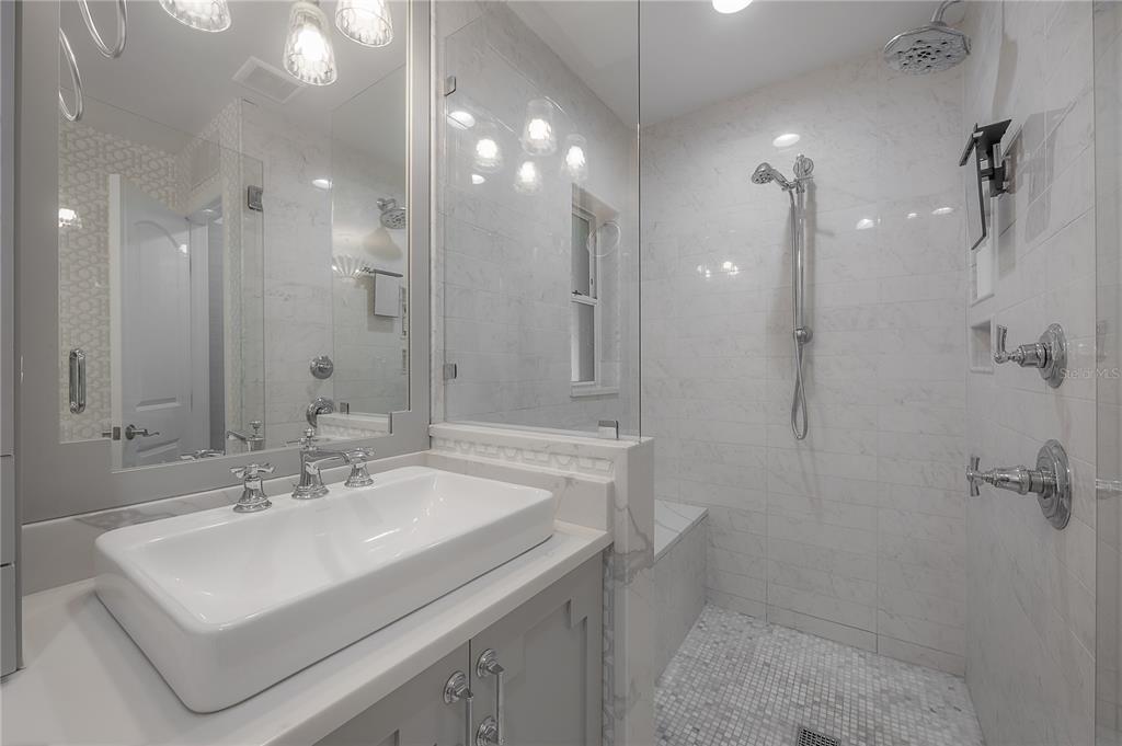 3108 West Villa Rosa Street Tampa, FL 33611 - Photo 25 of 58 a bathroom with a sink a toilet a shower and a mirror