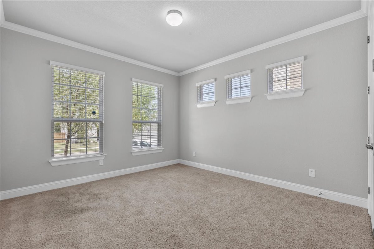 A well-proportioned bedroom with generous window lighting and plush carpeting awaits your personal touch.