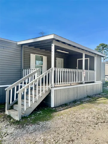 a view of a house with wooden fence