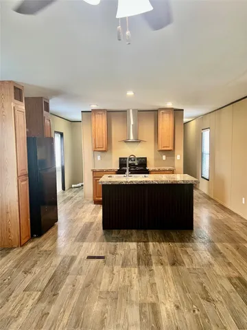 a kitchen with a refrigerator and a sink