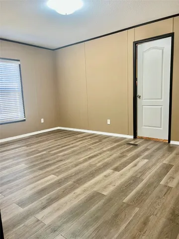 a view of a room with wooden floor