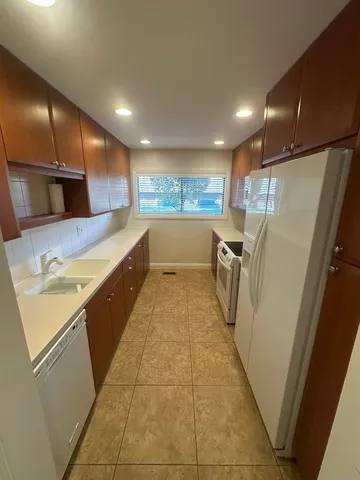 a bathroom with a tub a sink and a large mirror