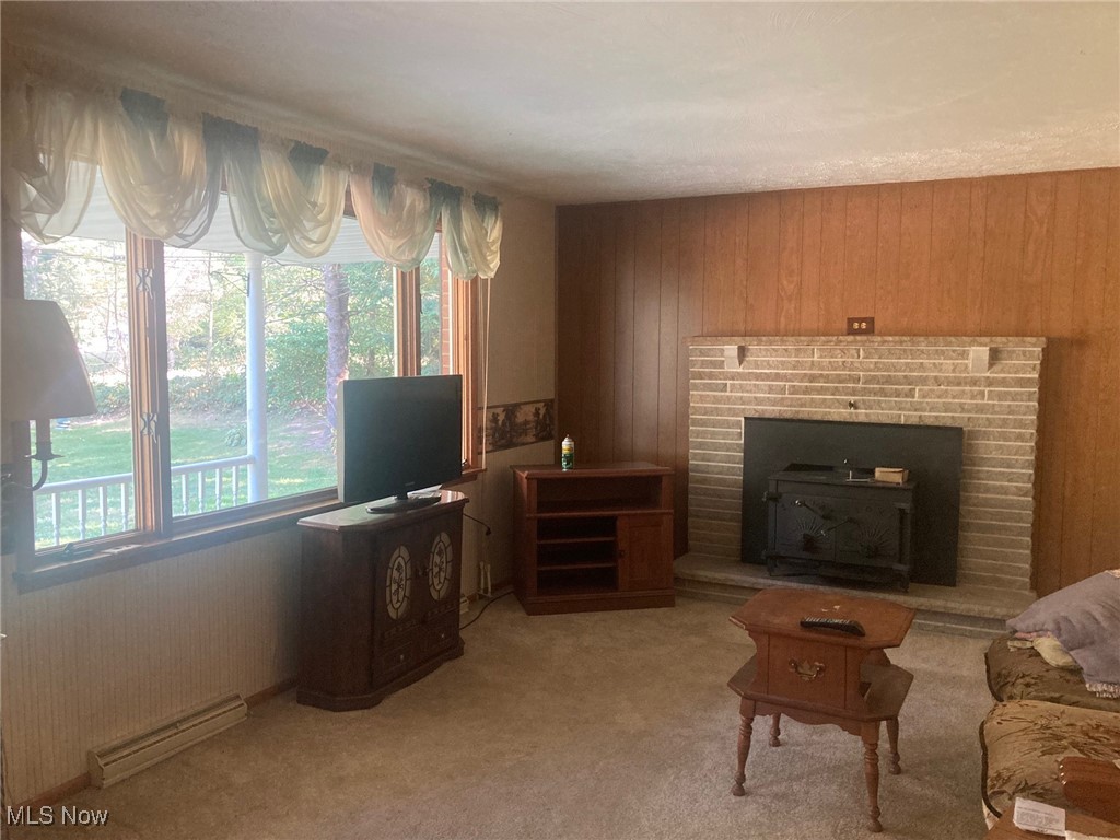 14225 Millersburg Road Southwest Navarre, OH 44662 - Photo 5 of 22 Living room with a fireplace, a wealth of natural light