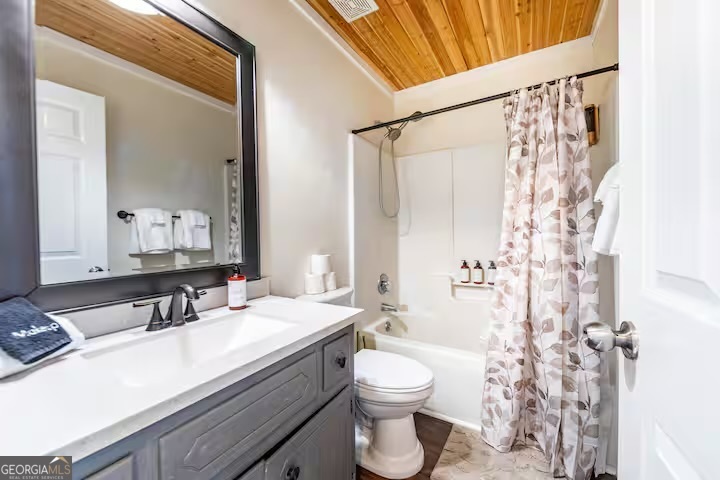 68 Franklin Road Eatonton, GA 31024 - Photo 23 of 28 a bathroom with a granite countertop sink toilet a mirror and shower
