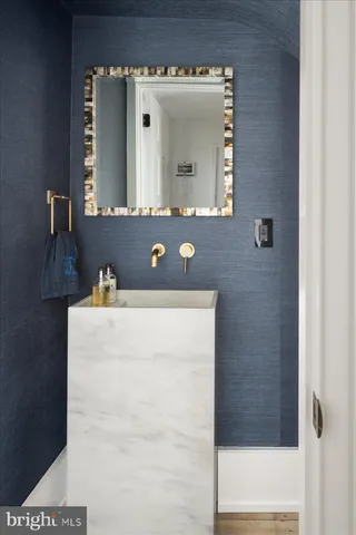 a bathroom with a sink vanity and a mirror