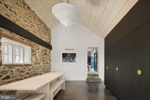a view of a livingroom with wooden floor and a chandelier