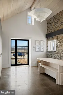 a view of a livingroom with furniture and staircase