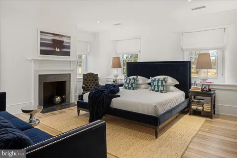 a bedroom with a bed and a fireplace
