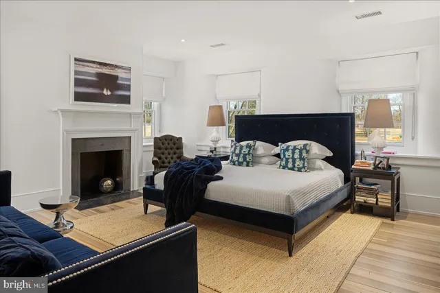 a bedroom with a bed and a fireplace