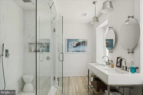 a bathroom with a sink a toilet and shower