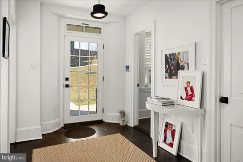 a view of entryway and hall with wooden floor