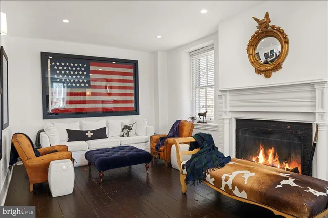 a kitchen with a sink a window and chairs