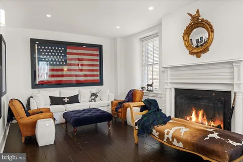a kitchen with a sink a window and chairs
