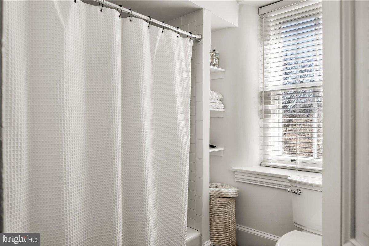 864 Grubbs Mill Road Newtown Square, PA 19073 - Photo 41 of 48 a bathroom with a shower curtain and a sink