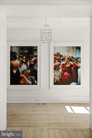 a view of a living room with a painting on the wall