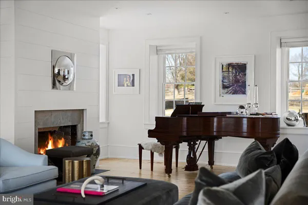 a living room with furniture fireplace and window
