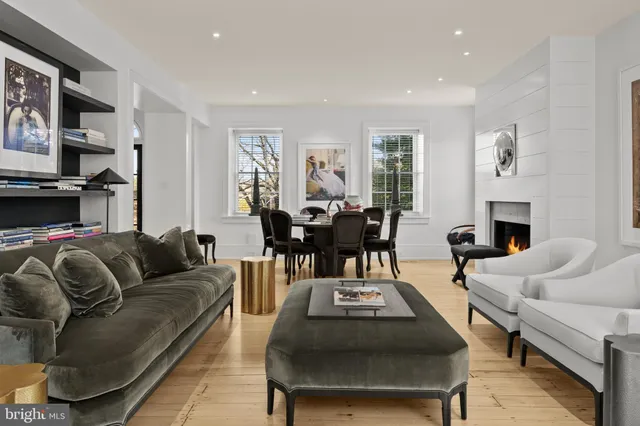 a living room with furniture fireplace and a window