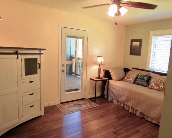 a bedroom with furniture and wooden floor