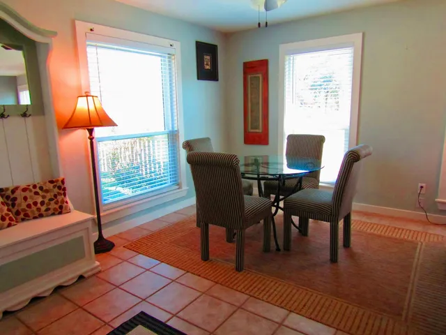 a dining room with furniture and wooden floor