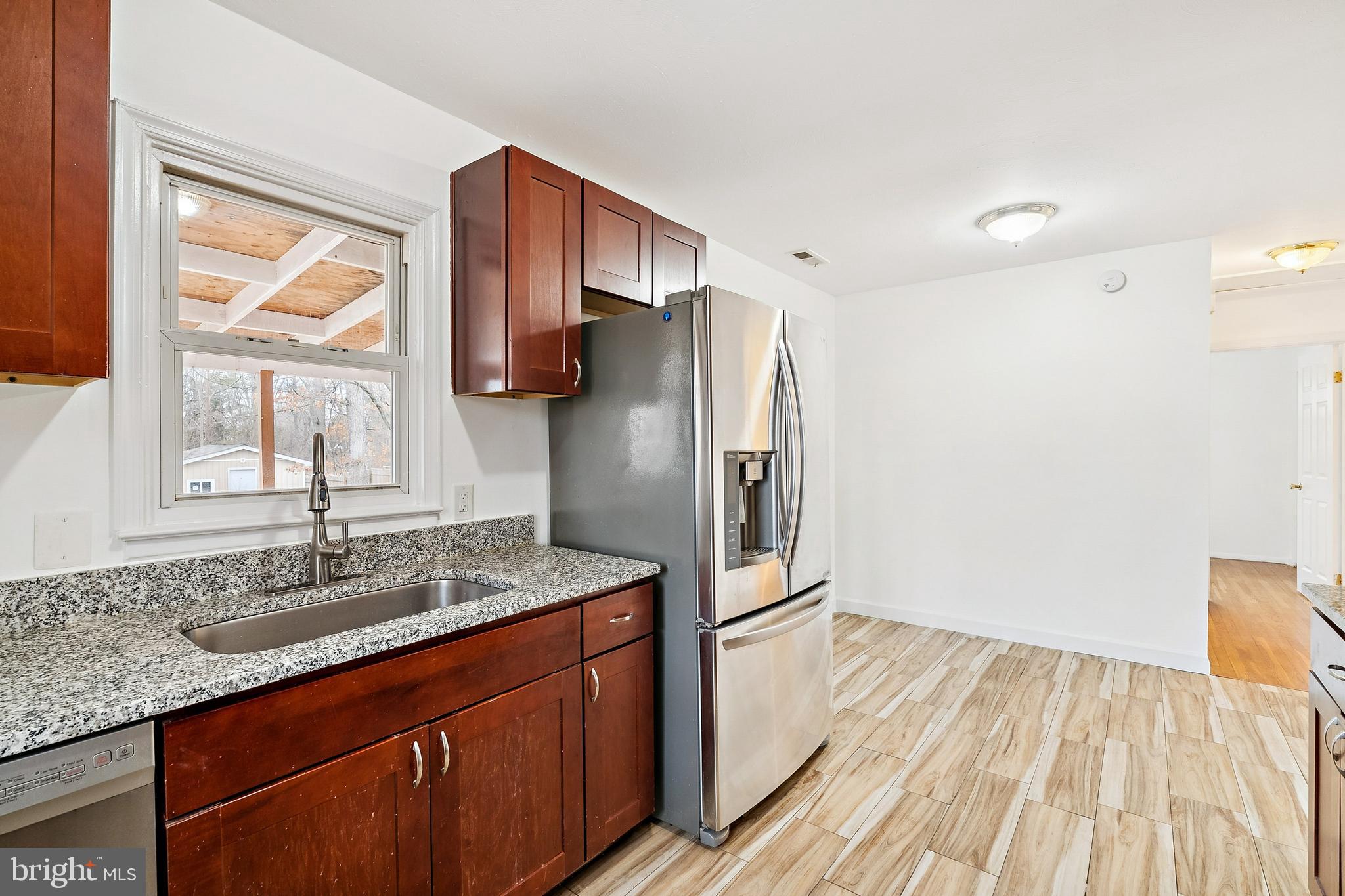 14508 Fullerton Road Woodbridge, VA 22193 - Photo 11 of 28 a kitchen with stainless steel appliances granite countertop a refrigerator and a sink
