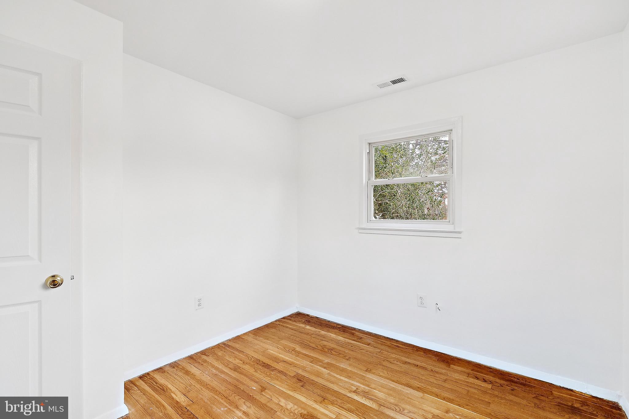 14508 Fullerton Road Woodbridge, VA 22193 - Photo 16 of 28 a view of a room with wooden floor and wall painting