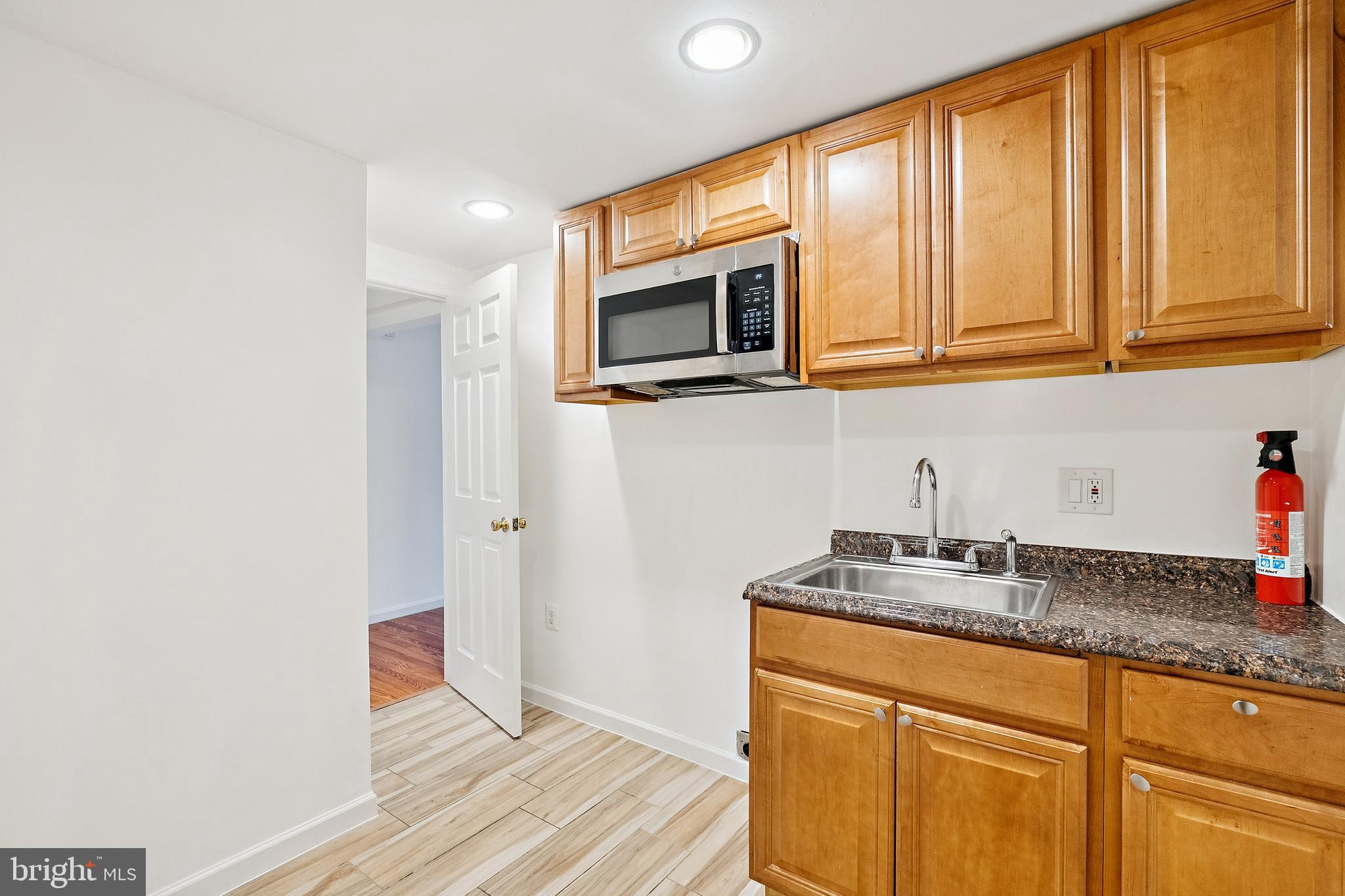 14508 Fullerton Road Woodbridge, VA 22193 - Photo 22 of 28 a kitchen with stainless steel appliances granite countertop a sink and a granite counter tops