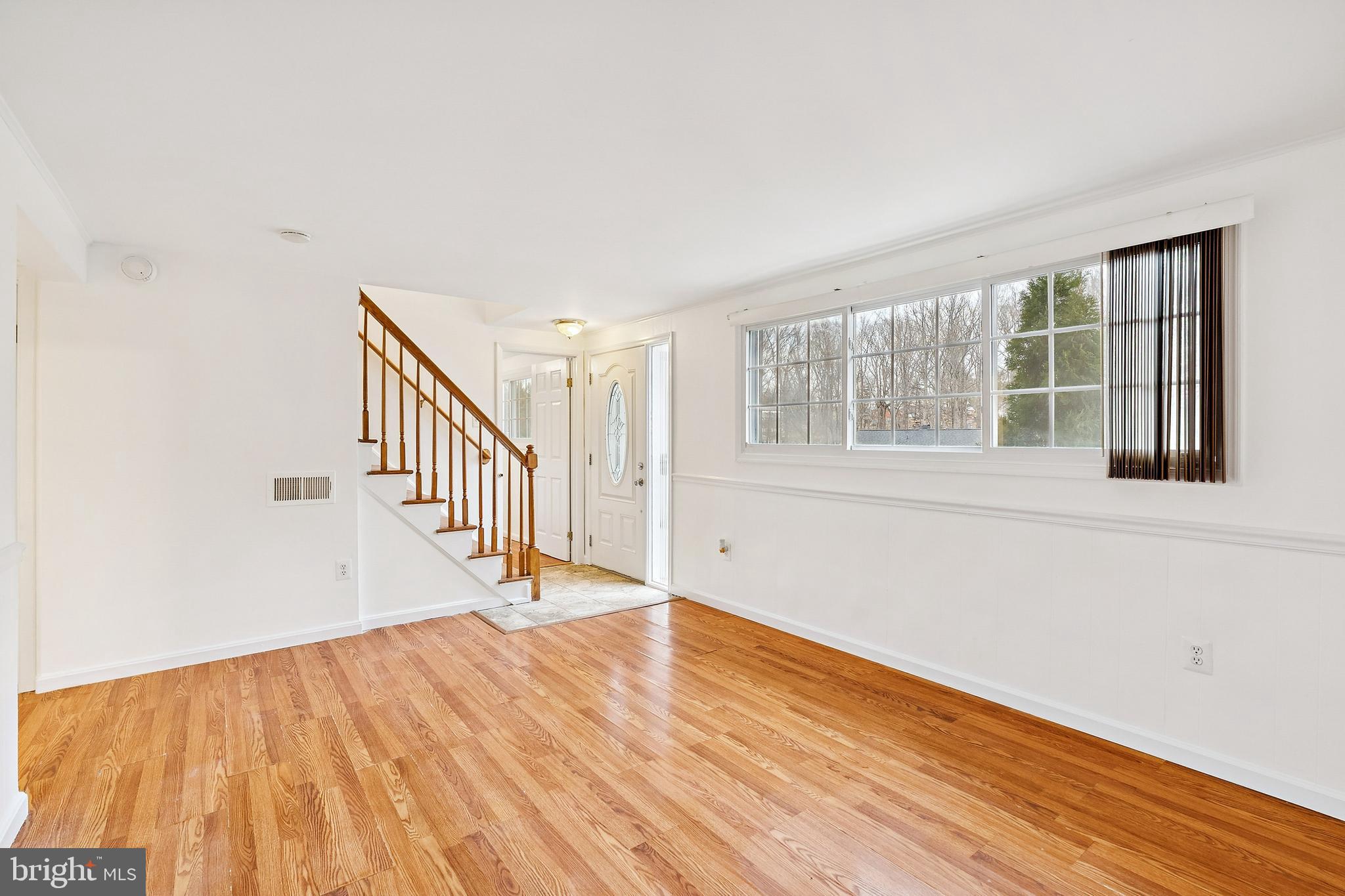 14508 Fullerton Road Woodbridge, VA 22193 - Photo 3 of 28 a view of an empty room with wooden floor and stairs