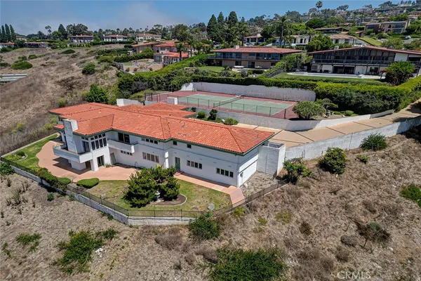 an aerial view of a house with yard swimming pool and outdoor seating