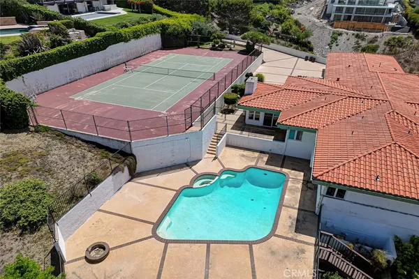 an aerial view of a house with garden space and street view