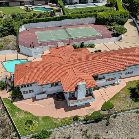 an aerial view of a house with garden space and street view