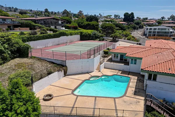 an aerial view of a house with garden space and street view